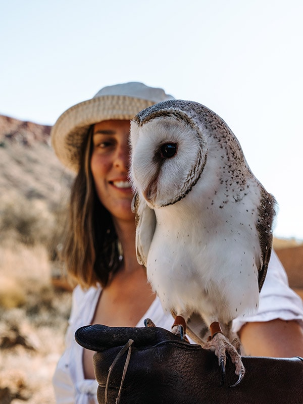 Woman holding a barn owl at Alice Springs Desert Park