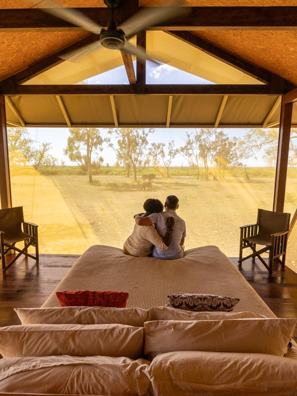 a couple hugging inside a glamping tent at Bamurru Plains