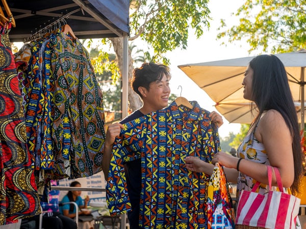 a couple shopping clothes at Parap Village Markets