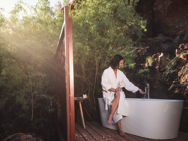 a woman relaxing in the outdoor tub at Kings Creek Station, Northern Territory