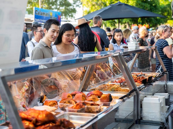 a couple picking food at Mindil Beach Sunset Market