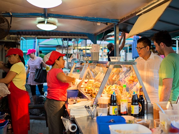 people buying at a food stall in Rapid Creek Markets