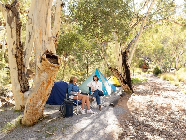 two women sitting outside their tents at Standley Chasm
