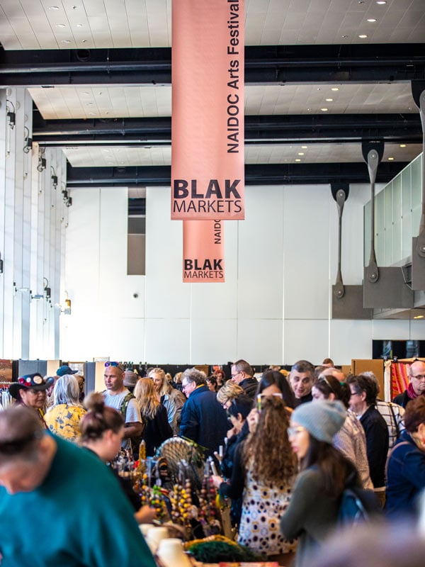 shoppers strolling around the stalls at Blak Markets