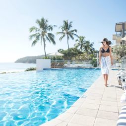 Woman walking by the pool at Tingirana Noosa