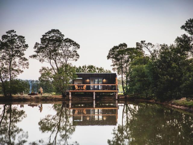 the Hideout cabin set on a beautiful dam of a working horse farm