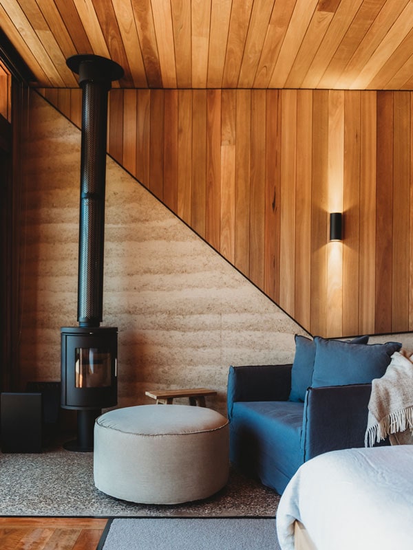 Fireplace and lounge area inside Basalt studio room in Orange