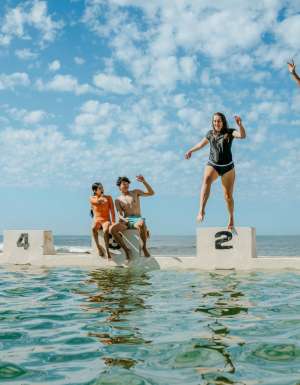 teens jumping into the water at Merewether Ocean Baths