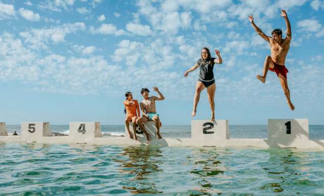 teens jumping into the water at Merewether Ocean Baths