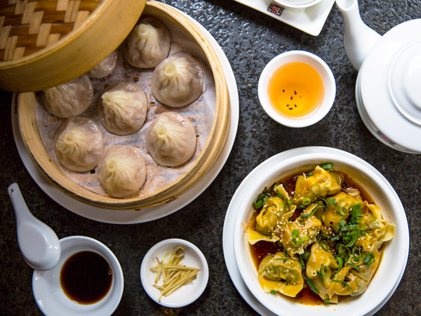an array of dumplings on the table at HuTong Dumpling Bar