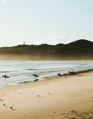 surfers at sunrise on Belongil Beach, Byron Bay