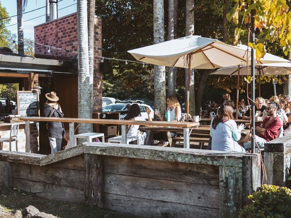 guests dining under huge umbrellas outside Roadhouse cafe, Byron Bay