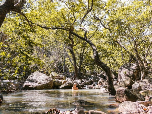 a lady dipping in the waters of Endeavour Falls in Arcadia 