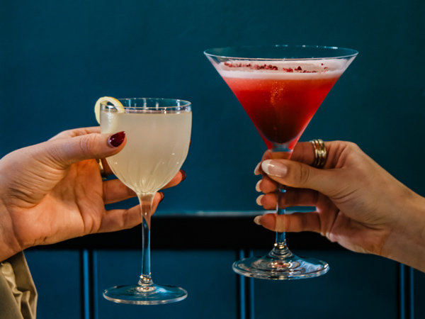holding two glasses of cocktail at Sip Champagne Bar, Ballarat