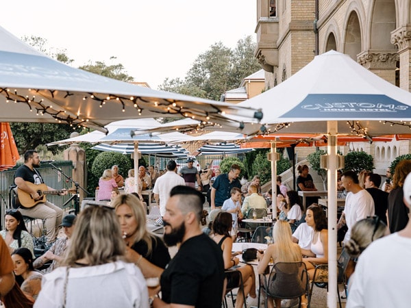 crowds of people outside Customs House Hotel