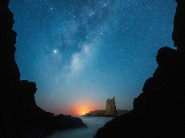 a night sky full of stars over Cathedral Rocks, Kiama