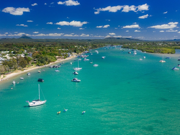 an aerial view of boats along Noosa River