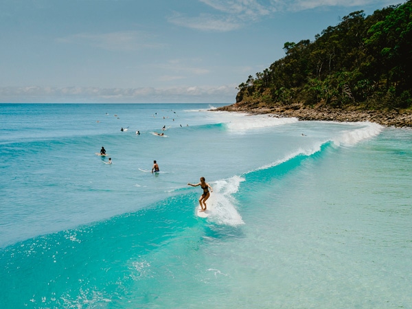 an overhead shot of people surfing at Noosa World Surfing Reserve