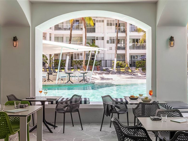 a restaurant beside a pool at Peppers Beach Club, Port Douglas accommodation