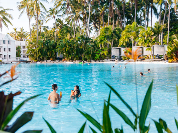 a couple relaxing in the pool at Sheraton Grand Mirage Resort, Port Douglas