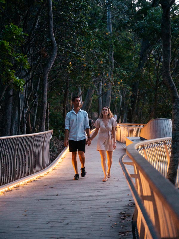 a couple walking along the seaside boardwalk, Noosa National Park