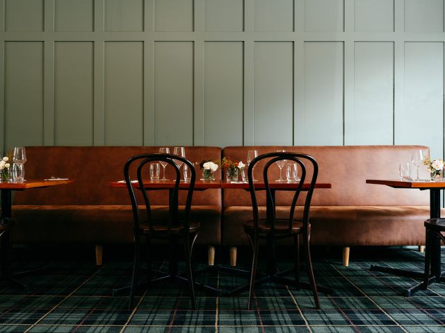 Brown leather seating and tables in a pub