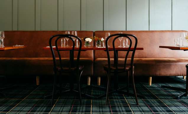 Brown leather seating and tables in a pub