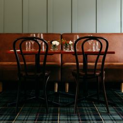 Brown leather seating and tables in a pub