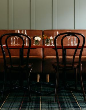 Brown leather seating and tables in a pub