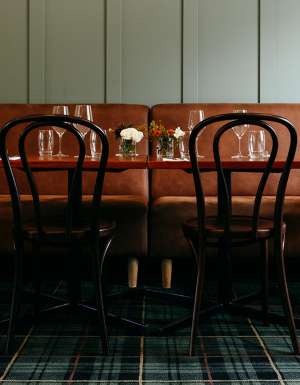 Brown leather seating and tables in a pub