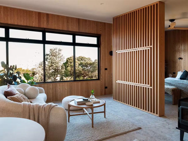 a rustic interior with a curved cream sofa at The Loft, Phillip Island