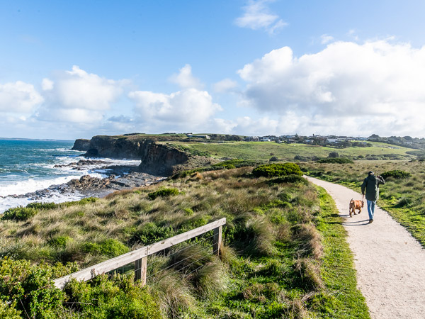 a man walking with his dog along the George Bass Coastal Walk, Phillip Island