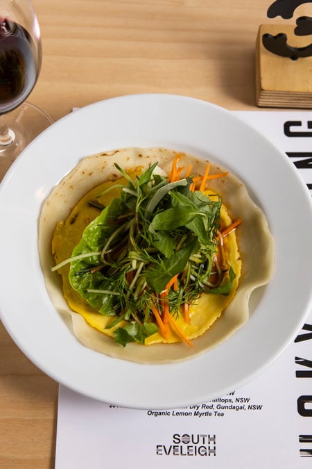 Overhead photo of an Asian-dish-with-a-glass-of-wine-at Lucky Kwong restaurant