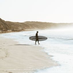 a surfer on Ocean Grove Main Beach