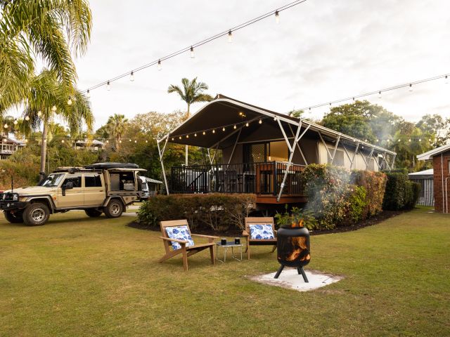 a bonfire setup outside a safari tent at Discovery Parks – Fraser Street, Hervey Bay