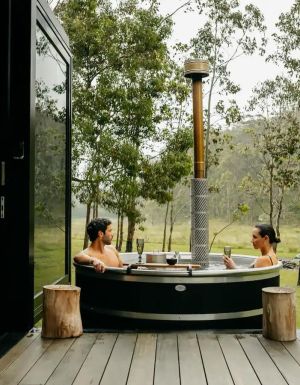 a couple relaxing in the outdoor tub at Billy’s Hideaway, Hunter valley