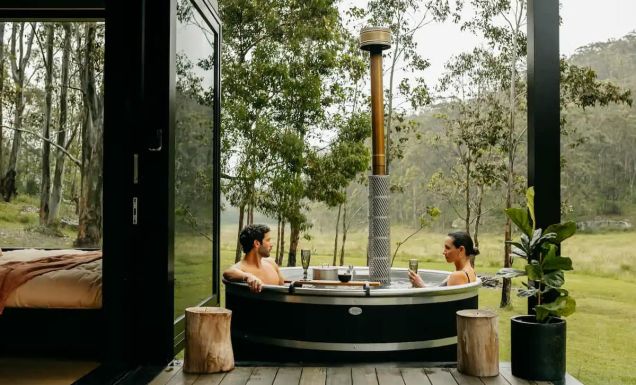 a couple relaxing in the outdoor tub at Billy’s Hideaway, Hunter valley