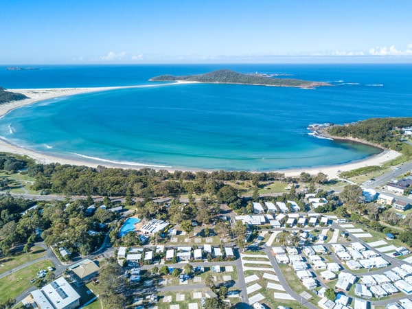High shot overlooking Fingal Bay Holiday park and the beach. 