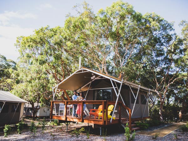 Family stand on bungalow at Koala Sanctuary Port Stephens. 