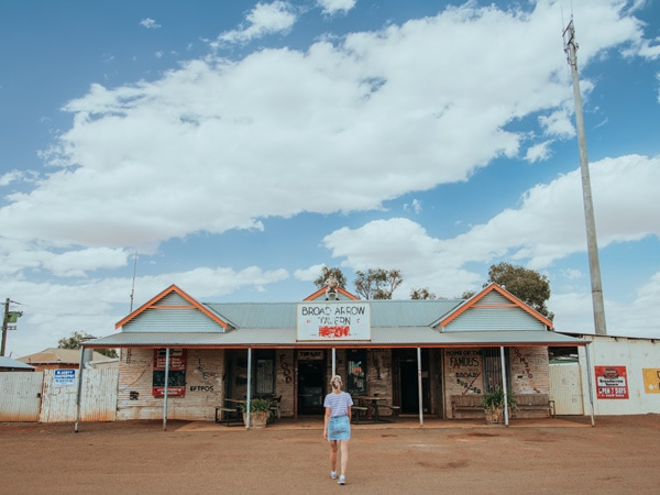 A girl standing out the front of the Broad Arrow Tavern in Kalgoorlie. (Image: Tourism Western Australia)