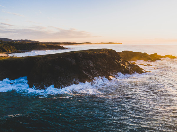 Scenic sunrise over Look At Me Headland, Emerald Beach. (Image: Destination NSW)