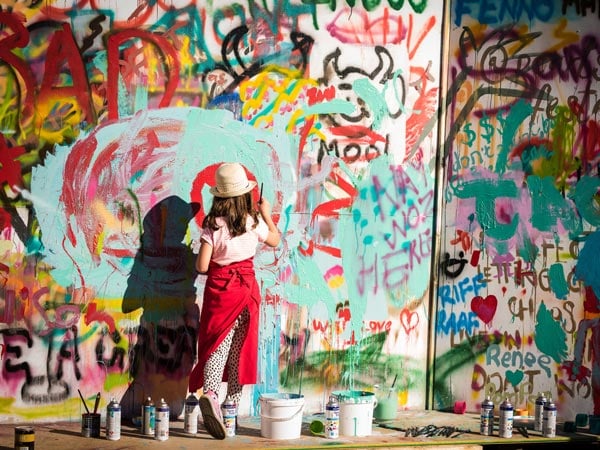 A girl is painting a wall at the Penola Arts Festival in South Australia. (Image: Penola Coonawarra Arts Festival)