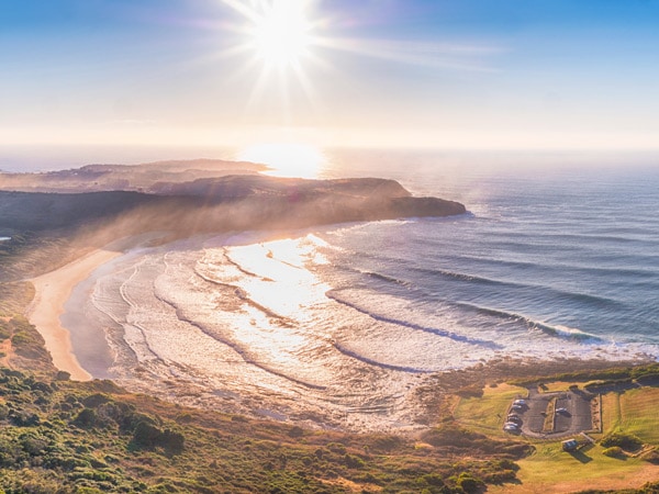 Sun rising over The Farm in Killalea State Park. (Image: Destination NSW)