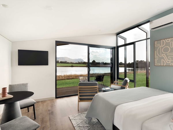 the bedroom with glass doors and windows at The Lane Retreat