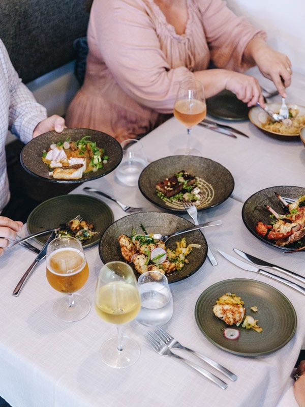 A group of people dine at Yellowtail Restaurant in Terrigal on the Central Coast.