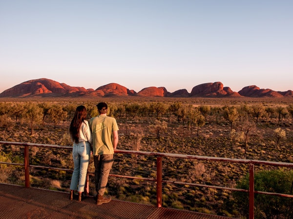 Couple admiring Kata Tjuta. (Image: Tourism NT and The Salty Travellers)