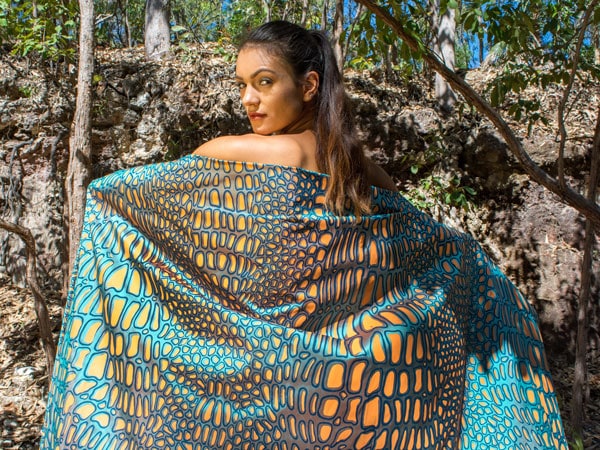 a woman flaunting an Indigenous fabric with beautiful patterns at the annual DAAF