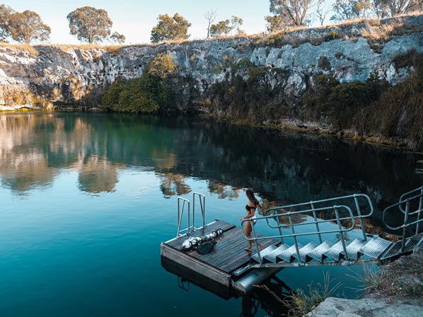 Woman swimming in Little Blue Lake Mount Gambier