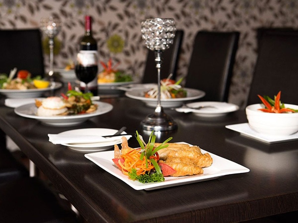 a dining table with a variety of dishes at Southern Thai Cafe, Mount Gambier
