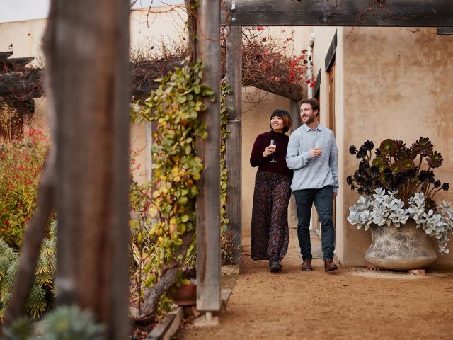 couple walking around Stefano Lubiana Wines tasmania